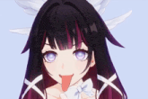 a close up of a girl with purple eyes sticking out her tongue