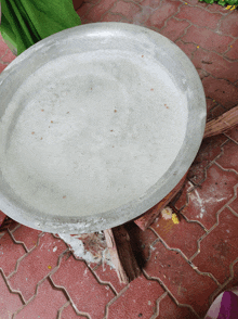 a metal bowl filled with white liquid sits on a wooden stool