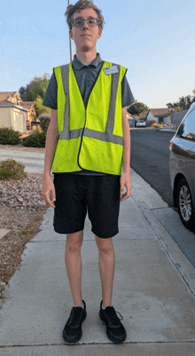 a man wearing a yellow vest with a name tag that says ' amanda ' on it