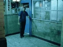 a man stands in a hallway with a sign that says libre on it