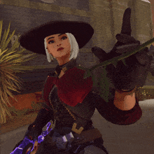 a woman in a black hat holds a red rose in her hand
