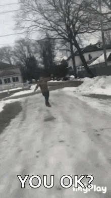 a black and white photo of a person walking down a snowy road with the words " you ok " written on the bottom