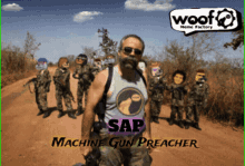 a man wearing a shirt that says sap machine gun preacher is standing in front of a group of soldiers