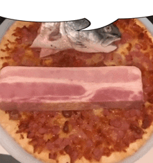 a pizza with a piece of bacon on it