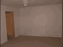 a bedroom with a ceiling fan and a door