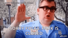 a man in a blue uniform says sorry folks park is closed