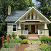 a small house with a porch and stairs is surrounded by trees .