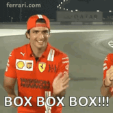 a man wearing a red hat and a red shirt with the words box box box written on it