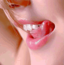 a close up of a woman 's lips with her tongue out