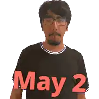 a man giving a peace sign with the words may 2 written on his shirt