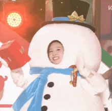 a woman dressed as a snowman with a top hat