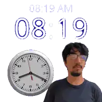 a man stands in front of a clock that says 08 19 am