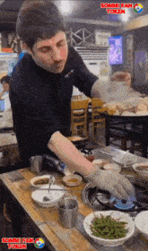 a man cooking food in a restaurant with sommi fan token written on the bottom