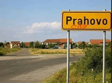 a yellow sign that says prahovo on it in front of a road .