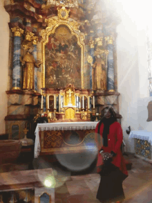 a woman stands in front of a church altar