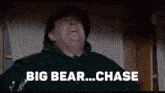 a man in a hat says " big bear ... chase "