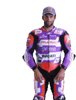 a man wearing a purple and orange motorcycle suit that says prima ducati on it