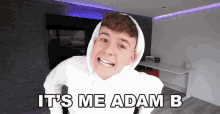 a man wearing a white hoodie with the words it 's me adam b on the bottom