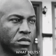 a man is standing in front of a door and asking what belts ?