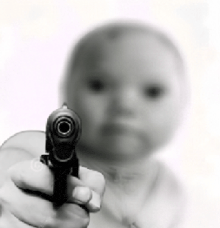 a baby is pointing a gun at the camera in a blurry photo .