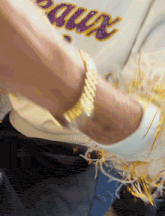 a person wearing a white shirt with the word bruins written on it