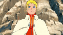 naruto is wearing a white cape and standing in front of a rocky mountain .