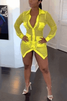 a woman is wearing a neon yellow dress and heels .