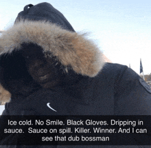 a man wearing a black parka with a fur hood