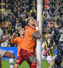 a soccer player with the number 4 on his jersey is trying to block a goal