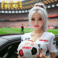 a woman holding a soccer ball that says sbobet