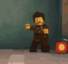 a lego man is dancing in a room with a red light .