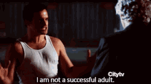 a man in a white tank top says i am not a successful adult in front of a man in a black suit