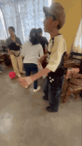 a group of people are dancing in a room with a pink ball