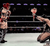 a woman in a wrestling ring is holding a bouquet of flowers