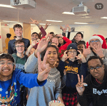 a group of young people are posing for a photo and one of them is wearing a thrasher sweatshirt