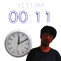 a man stands in front of a clock that says 1:11 am