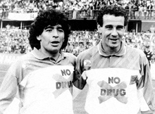 two soccer players wearing no drug shirts stand next to each other