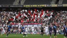 a soccer game is being played in front of a banner that says errea