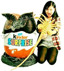 a woman is kneeling next to a kinder surprise