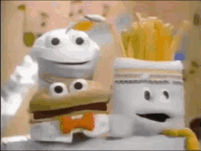 a hamburger and french fries are stacked on top of each other in a cartoon .