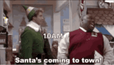 santa 's coming to town is written on a screen