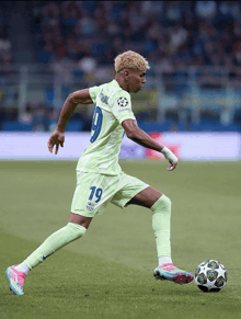a soccer player wearing a number 19 jersey kicks the ball