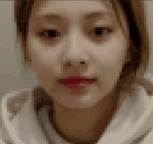 a pixelated image of a woman 's face with a red lip