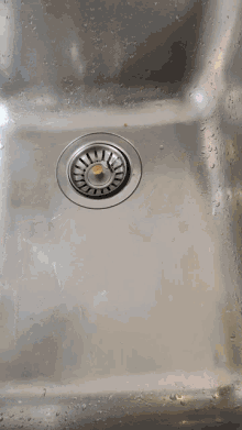 a stainless steel sink with a bottle that says ' dirty hands ' on the label