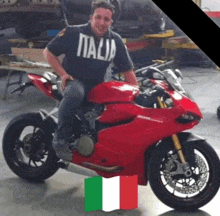 a man wearing a italia shirt sits on a motorcycle