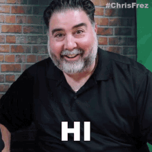 a man with a beard and mustache is smiling and saying hi