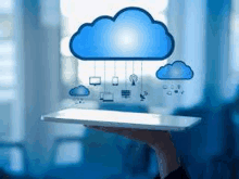 a person is holding a tablet in their hand with a cloud floating above it .