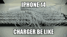 a bunch of wires laying on top of a keyboard with the words iphone 14 charger be like