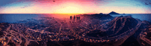 an aerial view of a city at sunset