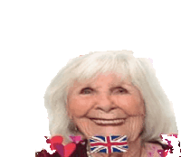 an elderly woman holds a british flag in her mouth